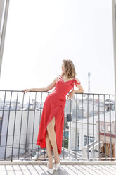 Asymmetric silk wrap dress with tie shoulder straps and high slit for modern elegance